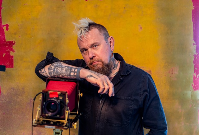 Clay Patrick McBride poses with a tintype camera at RIT, where he began teaching in 2014.