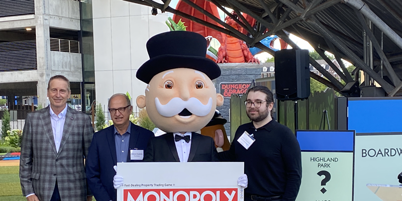 Greater Rochester Chamber of Commerce CEO Bob Duffy, Strong Museum of Play head Steve Dubnik and Hasbro representative John Marano pose with Mr. Monopoly to announce the upcoming Rochester version of the board game.