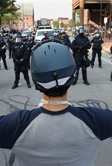 A protester faces off with a line of police at City Hall on  Sept. 16, 2020.