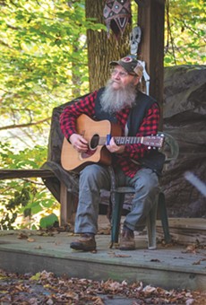 Bob Bunce plays guitar on one of the two stages he made himself on his rural property near Groveland, New York.