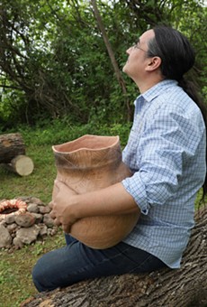 Mike Jones, a Native American artist, holds a clay pot he made for the Earth Altar project. His work, along with other altars, can be seen at the Ganondagan State Historic Site in Victor.