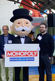 Greater Rochester Chamber of Commerce CEO Bob Duffy, Strong Museum of Play head Steve Dubnik and Hasbro representative John Marano pose with Mr. Monopoly to announce the upcoming Rochester version of the board game.